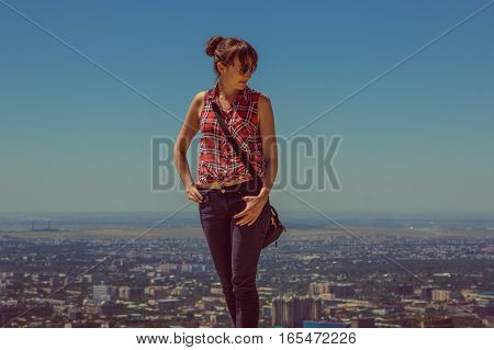 Young woman staying on the hill with city view Almaty Kazakhstan 2016