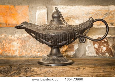 Beautiful vintage Aladdin lamp on the rocky background