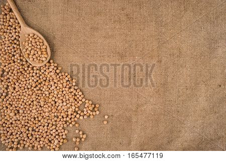 Dried white chickpeas ceci on sack. Top view.