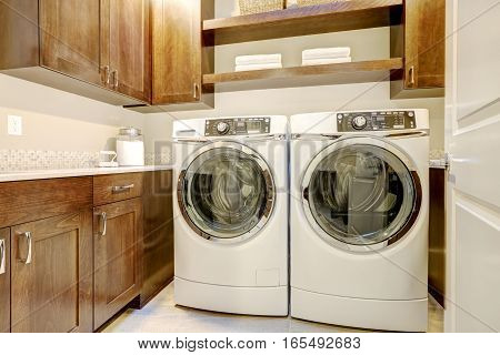 White And Brown Laundry Room With Modern Appliances