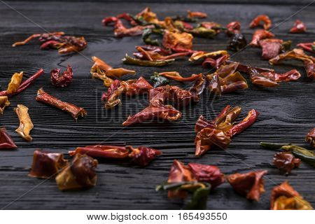 dark wooden texture background with dried pepper, close uo