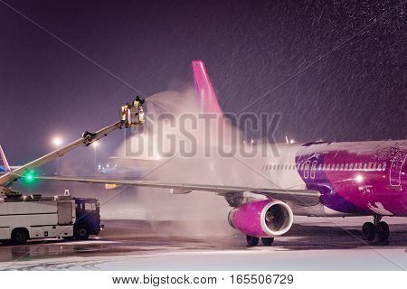 Deicing Passenger Airplane During Heavy Snow