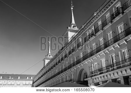 Madrid (Spain): facade of historic buildings in Plaza Mayor the main square of the city. Black and white
