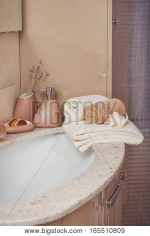 Stack of towels with a soap dispenser in a bathroom