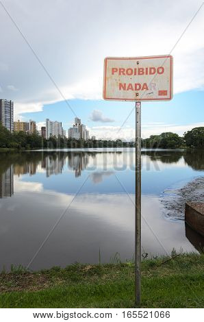 Londrina PR Brazil - December 24 2016: Warning sign Prohibited to swim in Lake Igapo of Londrina city. Proibido Nadar in portuguese.