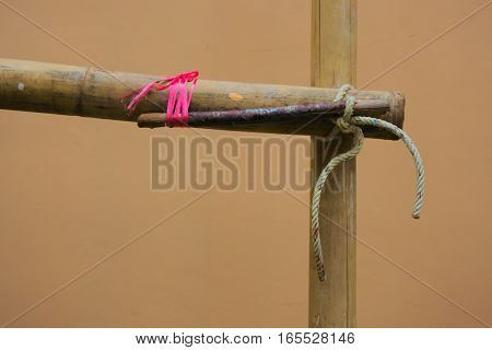 The scaffolding of bamboo lashed together with rope on the wrench.