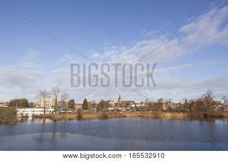 view over river Linge on dutch town of Leerdam in the netherlands under blue sky