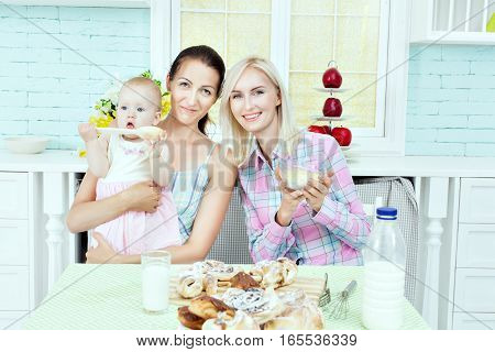 Young woman with a child on the kitchen table.