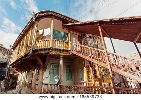 TBILISI, GEORGIA - OCT 16, 2016: Old house with wooden stairs in traditional georgian style built in historical area of city on October 16, 2016. Tbilisi has population of 1.5 million people