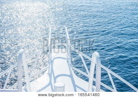 beautiful white yacht bow on blue water surface background