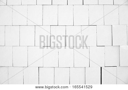 White calcium silicate bricks piled high in a stack