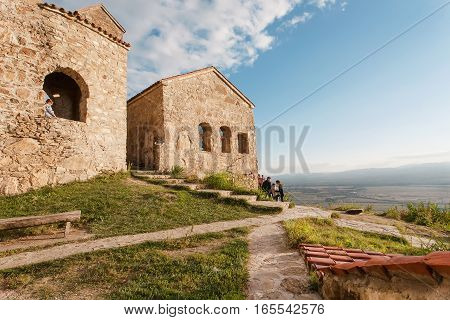 NEKRESI, GEORGIA - OCT 1, 2016: Hill top with people discovering the ancient Christian monastery in Alazani valley on October 1, 2016. Nekresi monastery was erected in 4th - 7th century