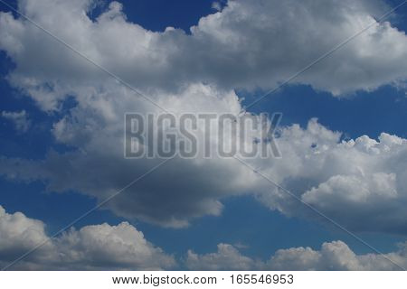 cumulus clouds bright sun in a serene blue sky