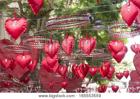 Red hearts hanging and moving in neighbourhood festival of Gracia district in Barcelona. Suitable for Valentine's Day or Love ideas.
