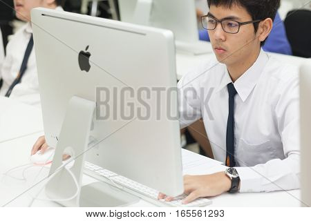 Bangkok, Thailand - November 17, 2015 : 
King Mongkut's Institute of Technology Ladkrabang is a research and educational institution in Thailand.
A class of students in front of their screens study computer science.