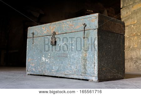 Old wooden toolbox, closed with a padlock, timeworn paint