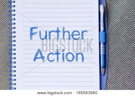 Further action text concept write on notebook