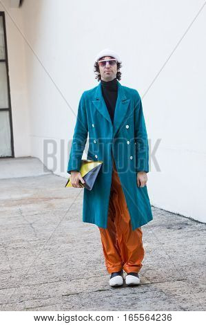 MILAN ITALY - JANUARY 15: Fashionable man poses outside Damir Doma fashion show building during Milan Men's Fashion Week on JANUARY 15 2017 in Milan.