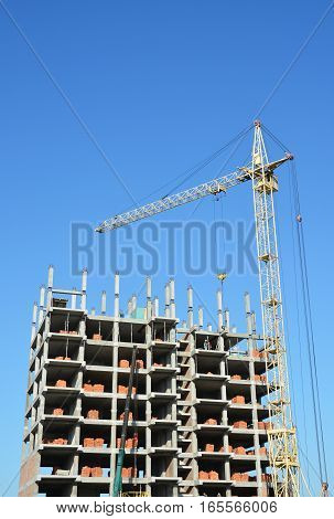 Tower Crane and Building Constructors on Construction Site. Building with two cranes on construction site with builders. Building high rise.