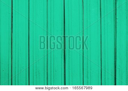 Texture of old wooden planks with peeling color paint