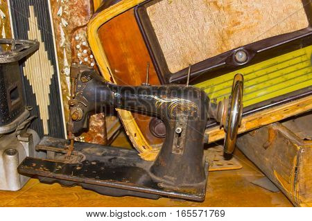 The dump the old stuff - old sewing machine radiogram primus suitcase accordion - retro background