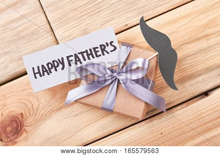 Father's Day gift and mustache. Greeting card and present box. Creative greeting for daddy.