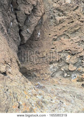 Rocks that are layered both horizontally and vertically as seen up close at Fort Rock State Park in the Fort Rock Valley in Lake County in Southern Oregon on a winter day.