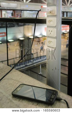Curitiba, PR, Brazil - December 26, 2016: Free socket for smartphone charging 220v at Afonso Pena International airport in Curitiba.