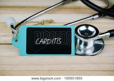 Wooden tag written with Carditis and stethoscope on wooden background. Medical and Healthcare concept.