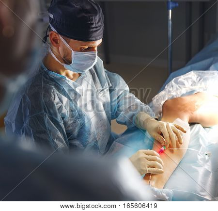 doctor and an assistant in the operating room for surgical venous vascular surgery clinic