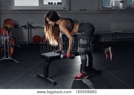 Fitness Girl Execute Exercise With Dumbbells, On Broadest Muscle Of Back.