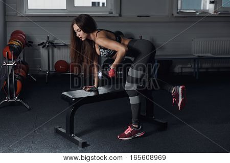 Fitness Girl Execute Exercise With Dumbbells, On Broadest Muscle Of Back.