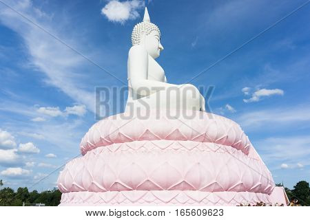 White Buddha statue on blue sky .