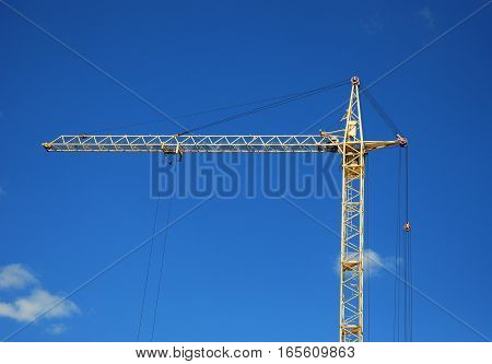Crane Construction with Copy Space against Blue Sky Background. Tower Crane in Construction site.