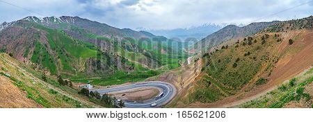 The foggy evening in Qurama Mountains the twisted highway leads from the Kamchik Pass to Tashkent Region Uzbekistan.