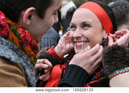 outdoor portrait of two young ukrainian people in traditional ukrainian clothes in the meeting