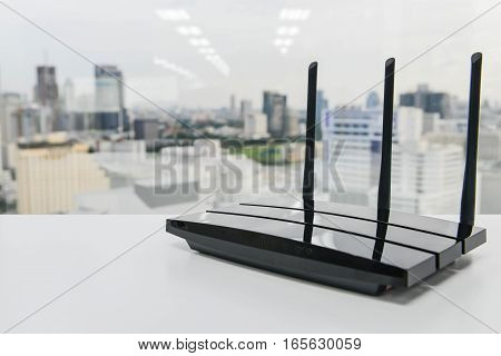 Black three poles wifi router on the white table