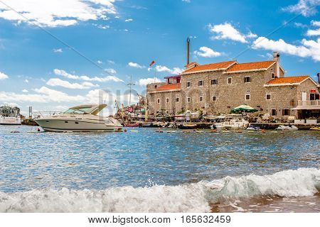 PETROVAC, MONTENEGRO - SEPTEMBER 20, 2016:The old town of Petrovac with an ancient fortress and a bay for tourist and fishing vessels, Montenegro.