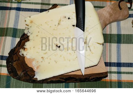 Cutting board with slice of pecorino cheese