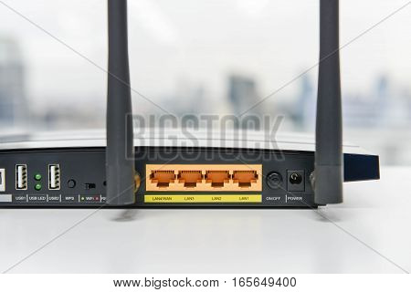 Back panel of black wifi router on the white table