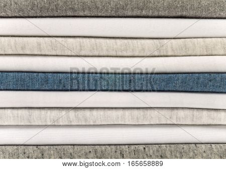 Stack of white gray and heather blue t-shirts