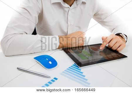 Business person analyzing financial statistics displayed on the tablet
