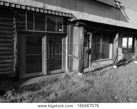 Large windows on an old abandoned building in the small town of Oakridge in Lane County in Western Oregon on a spring day.