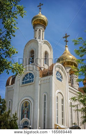 Church Dmitry Rostovsky - Orthodox church in Rostov -on-Don Russia . A bright day in May the sun glare on the gilded dome .