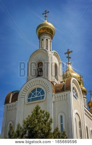 Church Dmitry Rostovsky - Orthodox church in Rostov -on-Don Russia . A bright day in May the sun glare on the gilded dome . Belfry.