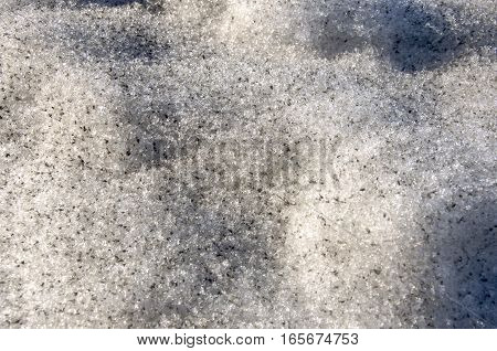 Snow with ice like a glass and crystal in early spring