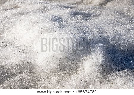 Snow with ice like a glass and crystal in early spring