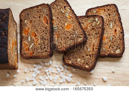 Healthy homemade bread. Slices of whole grain rye bread with pumpkin seeds and dried apricots