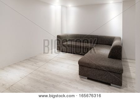 Sofa With Chaiselongue In Empty Renovated Apartment