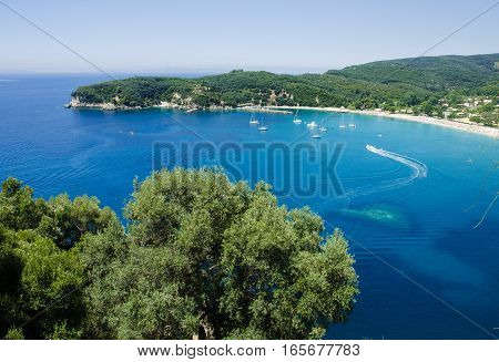 View from hill on boats on blue waters of Valtos bay and beach Parga Greece